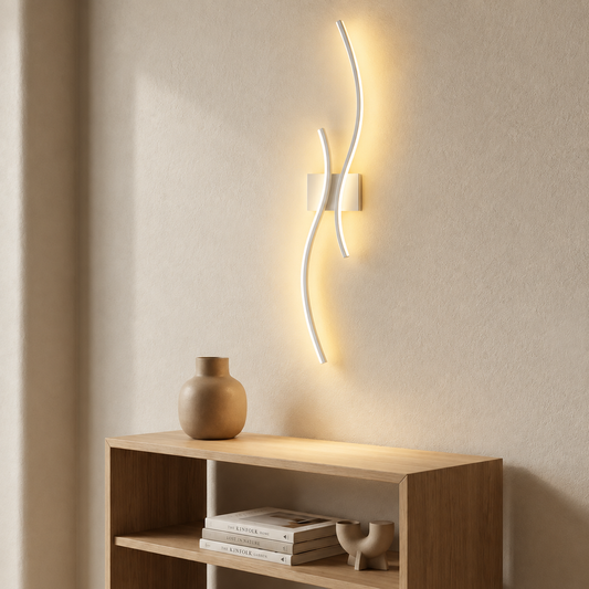 Curved cordless wall light casting a soft glow on a bare wall