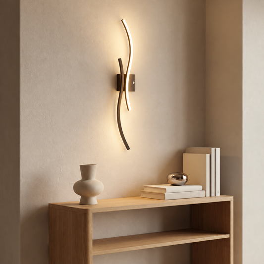 Black curved cordless wall light glowing above a wooden console table