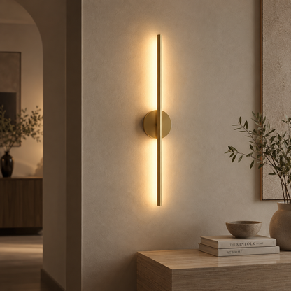Gold linear cordless wall light on a bare wall